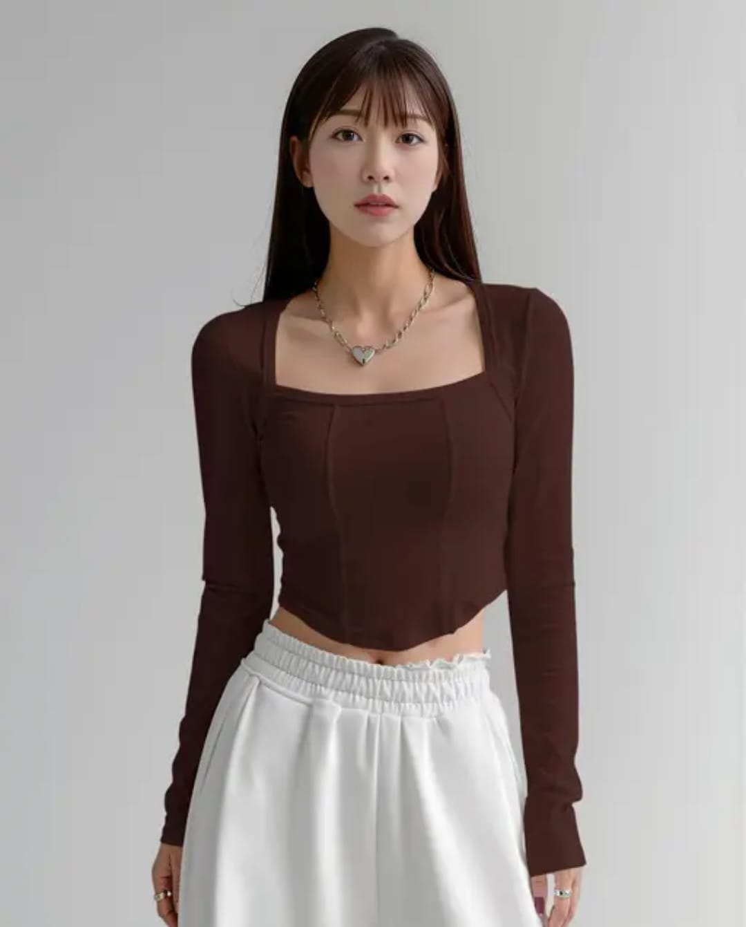 brown crop top age Alt Text: Woman wearing a chocolate brown square neck full sleeve corset style ribbed crop top