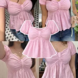 Woman wearing a blush pink puff sleeve peplum top with a sweetheart neckline and gathered bodice