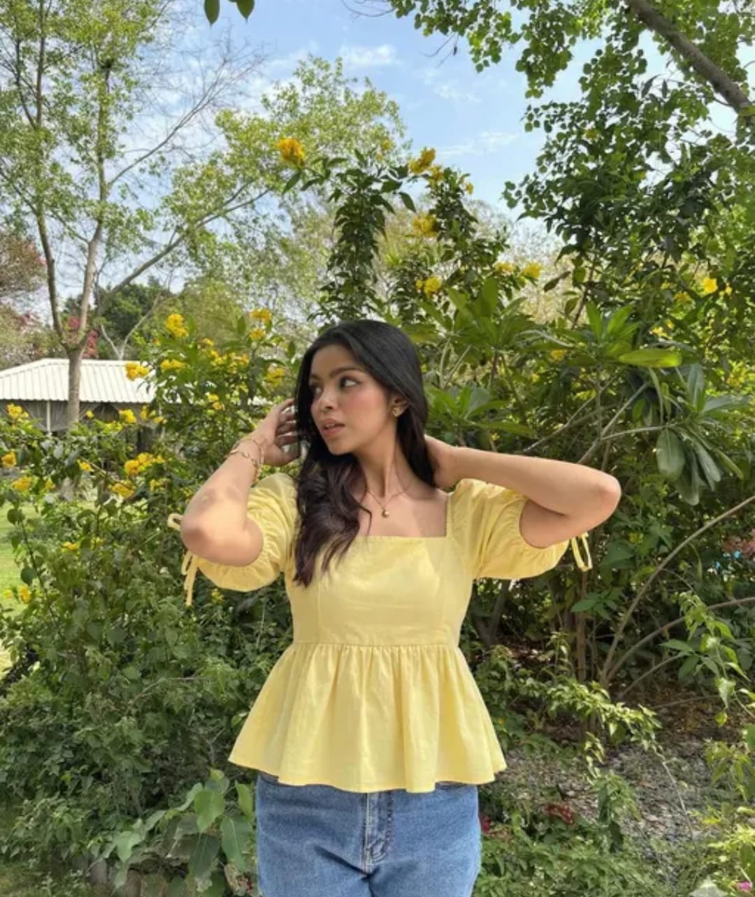 Woman wearing a sunny yellow puff sleeve peplum top
