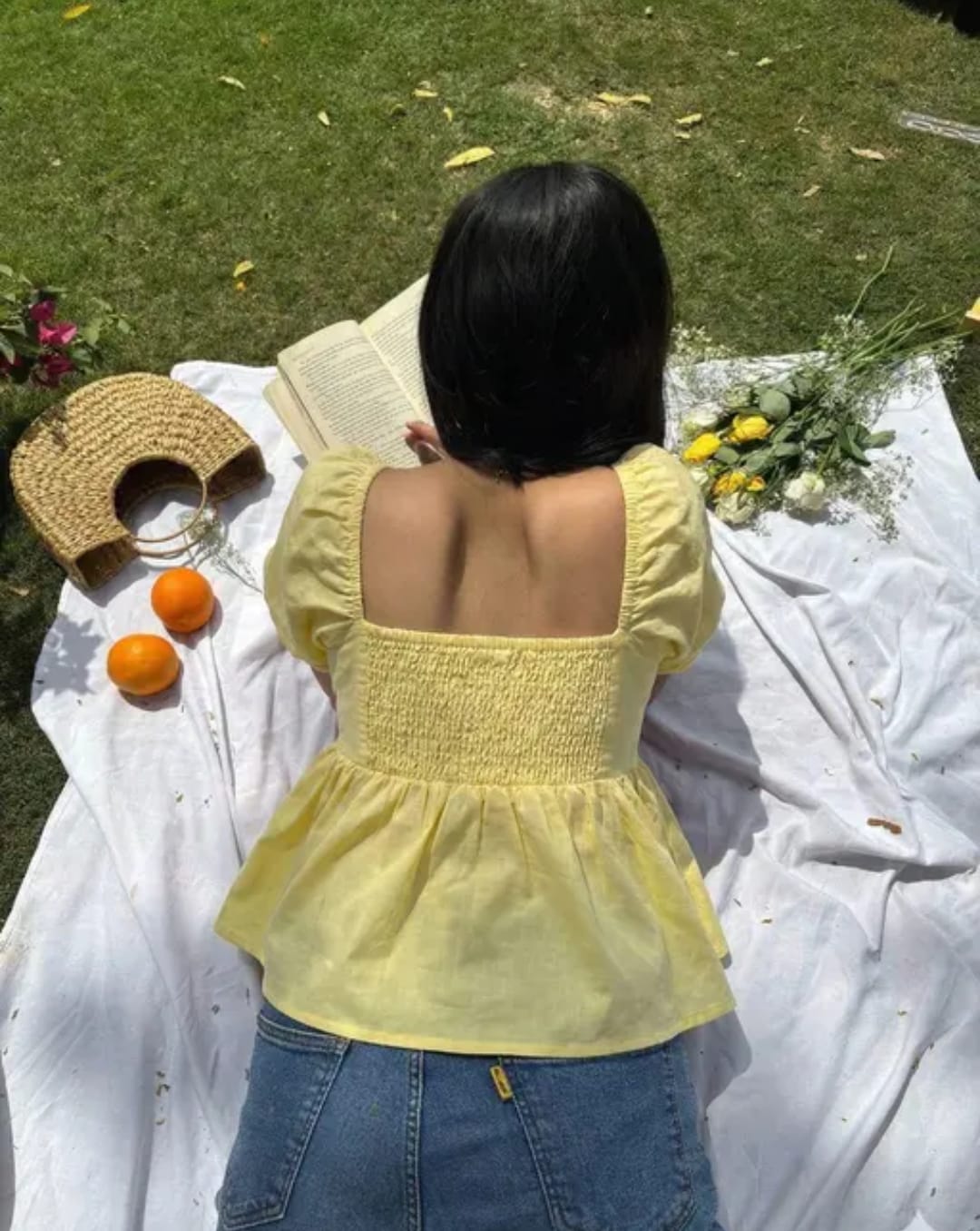 Woman wearing a sunny yellow puff sleeve peplum top