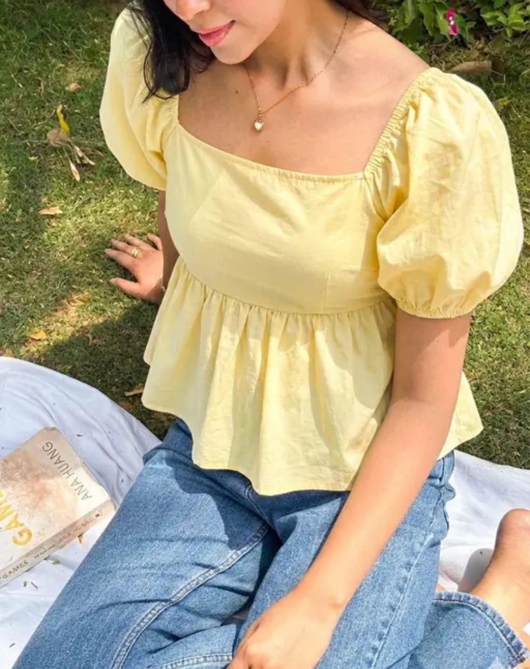 Woman wearing a sunny yellow puff sleeve peplum top