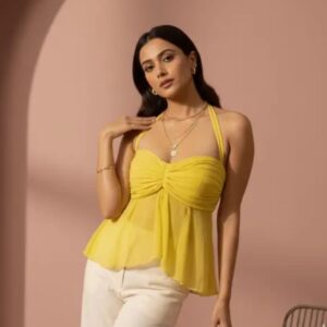 Woman wearing a yellow halter neck peplum top with a ruched sweetheart neckline